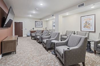 A waiting room filled with chairs and a television